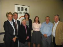 Group stand in front of Redfern Legal Centre banner