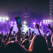 Crowd at a festival with hands in the air holding mobile phones