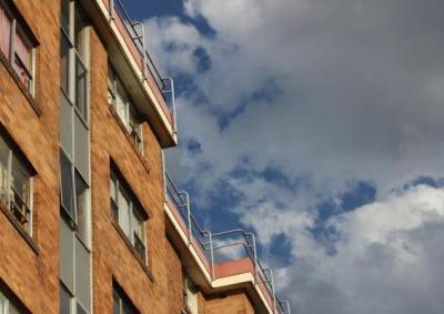 Tenancy housing low angle brown apartment black block with cloudy skies 