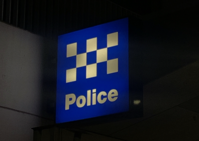 Image of light up police sign at night