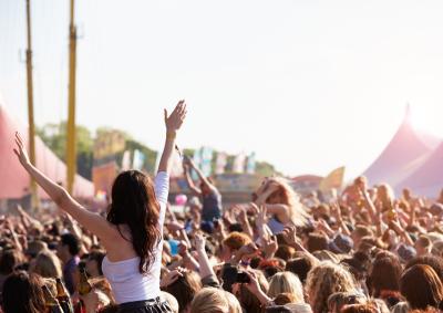 Girl crowd surfing at music festival