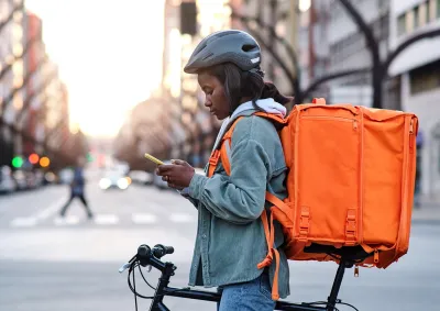 Person on a bike using their mobile device