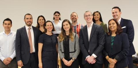 Group of smiling people standing together in a row