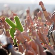 Close up of a crowds raised hands at a music festival.