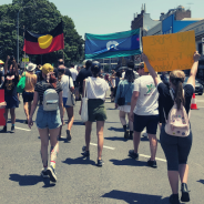 Protesters on City road holding Aboriginal flags