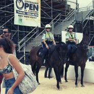 Two police on horses at a festival 