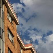 Tenancy housing low angle brown apartment black block with cloudy skies 