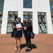 Two women stand outside Parliament House